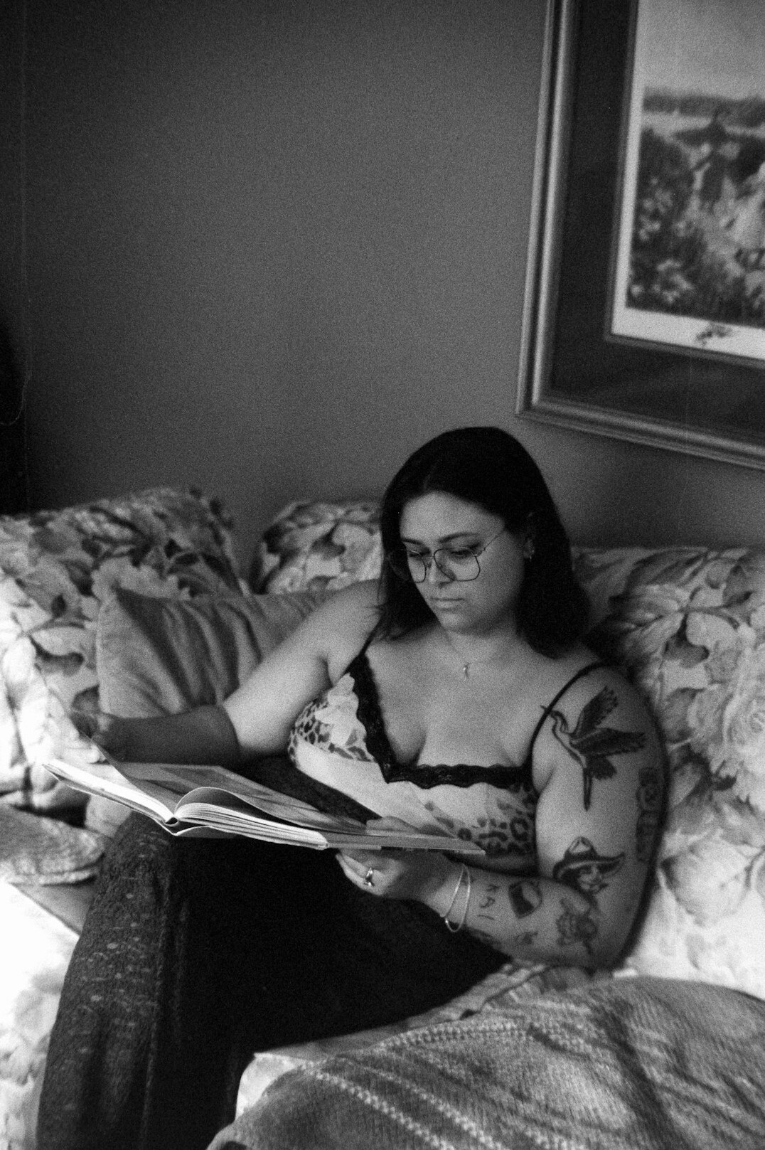 Woman writing in a journal at a sunlit desk at home