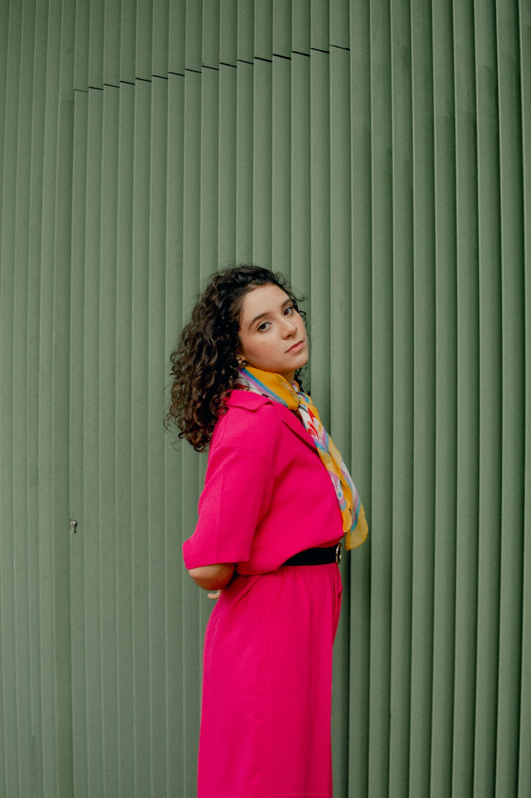 Studio portrait of a Mexican woman with curly hair smiling